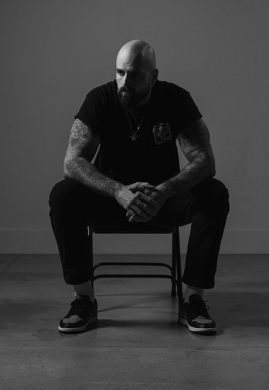 Connor Gilbert, creator of Mayhem to Mastery, seated on a chair